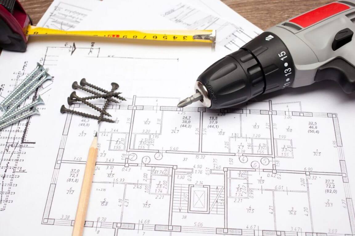 Plan pour construction d'une maison, crayon, ruban à mesurer, vis et tournevis électrique